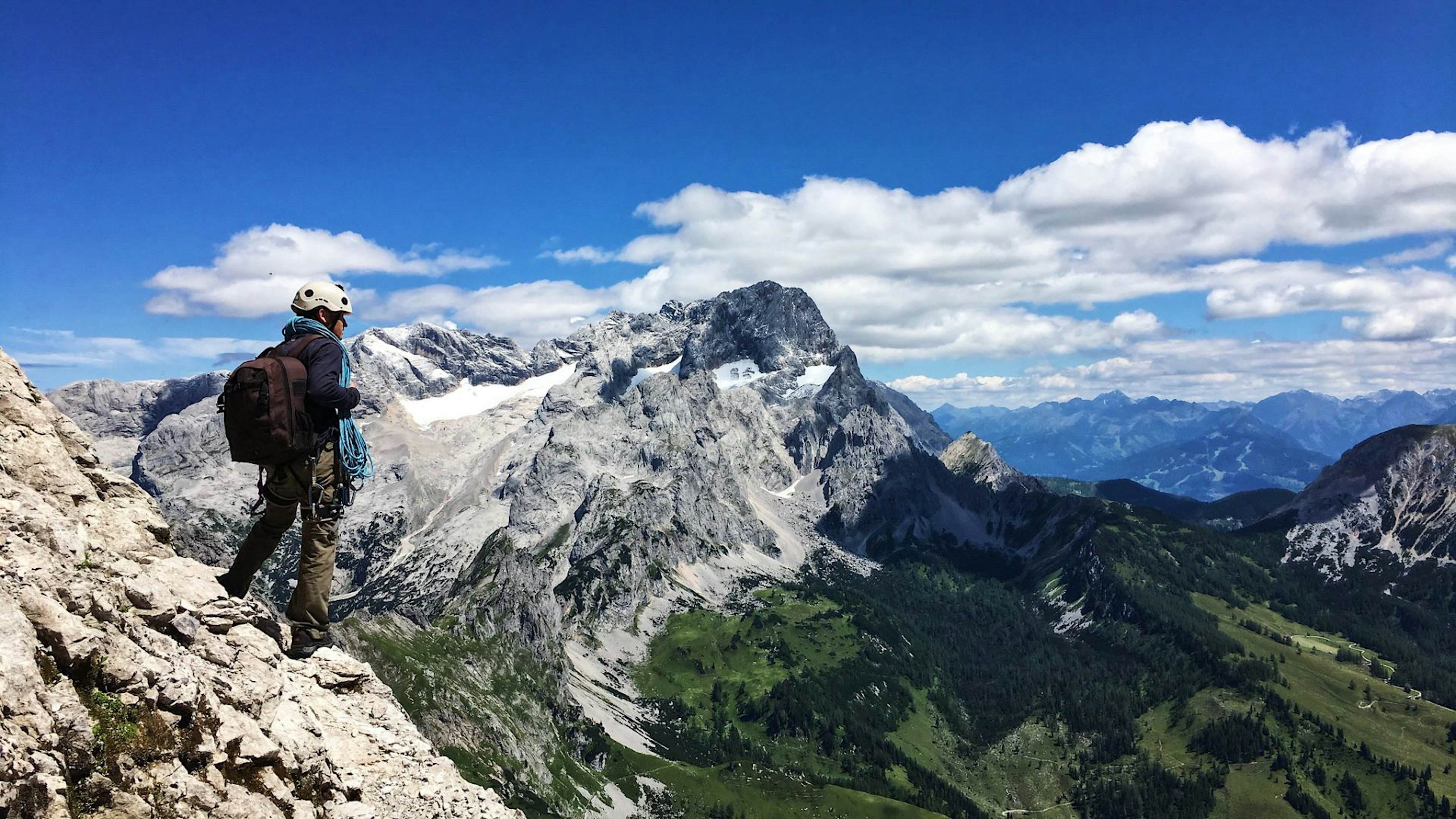 person hiking on a mountain top