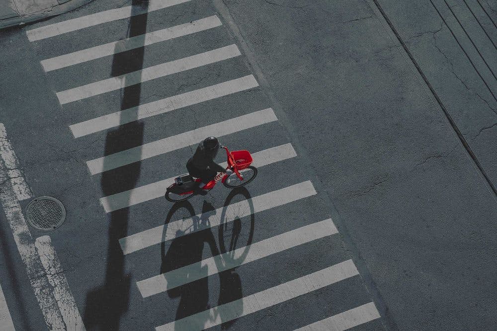 Person riding a bike through a crosswalk