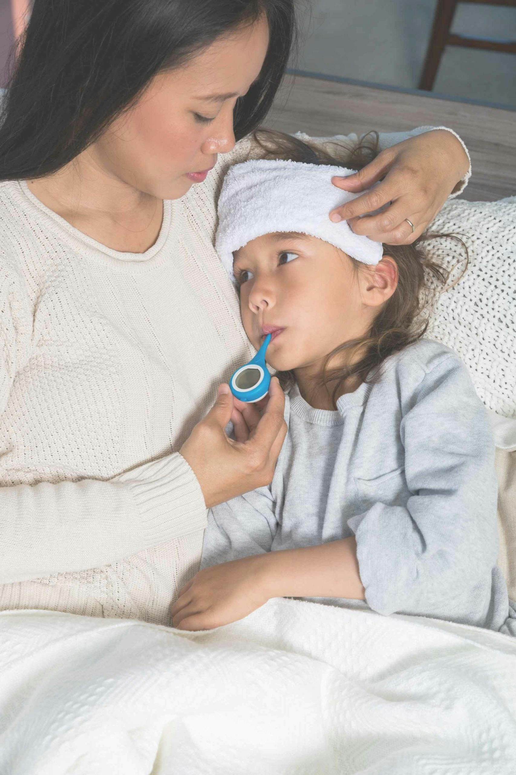 Women taking a child's temperature