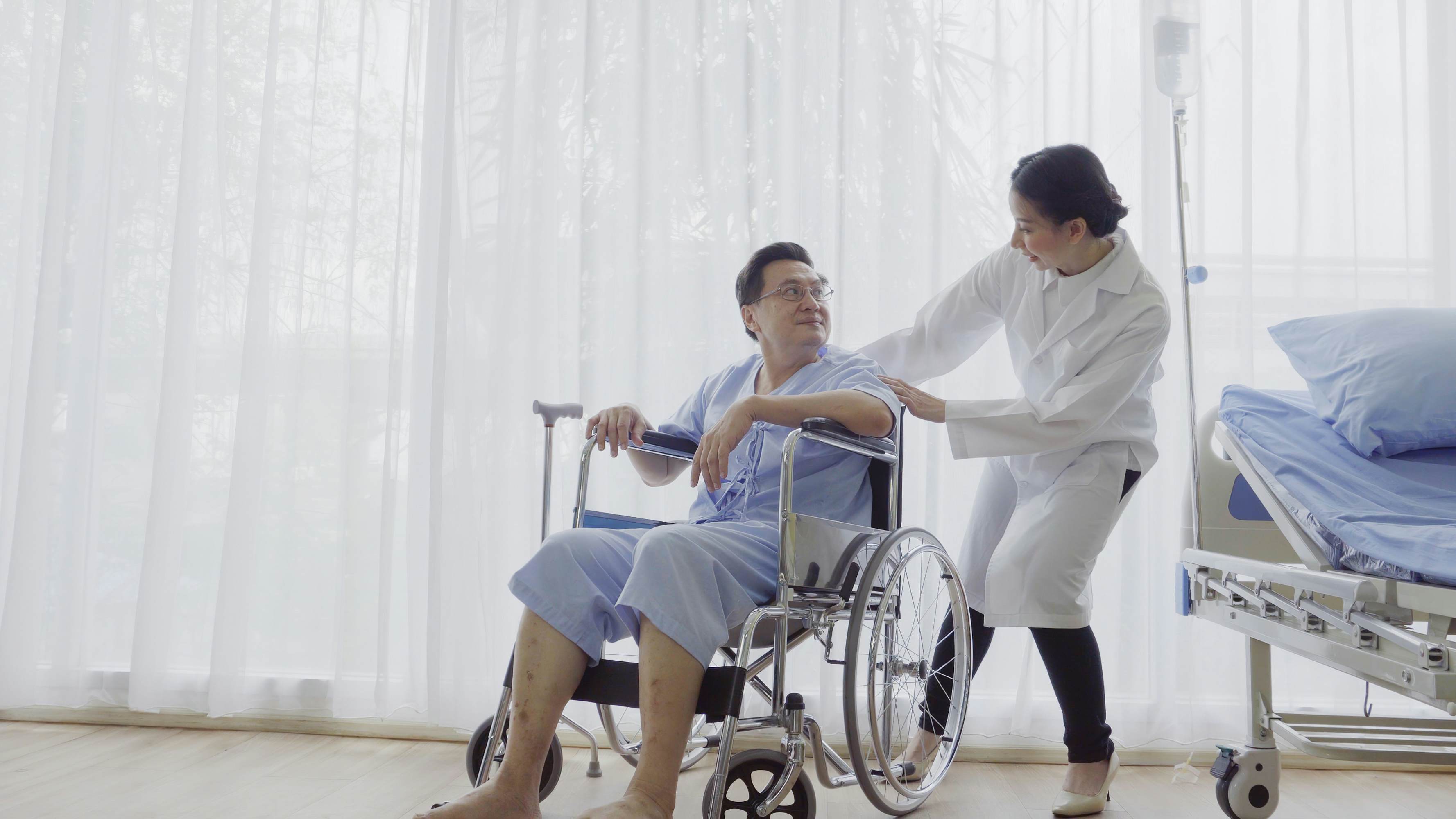 medical staff pushing patient wheel chair
