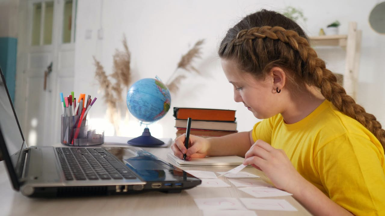 girl doing work on laptop