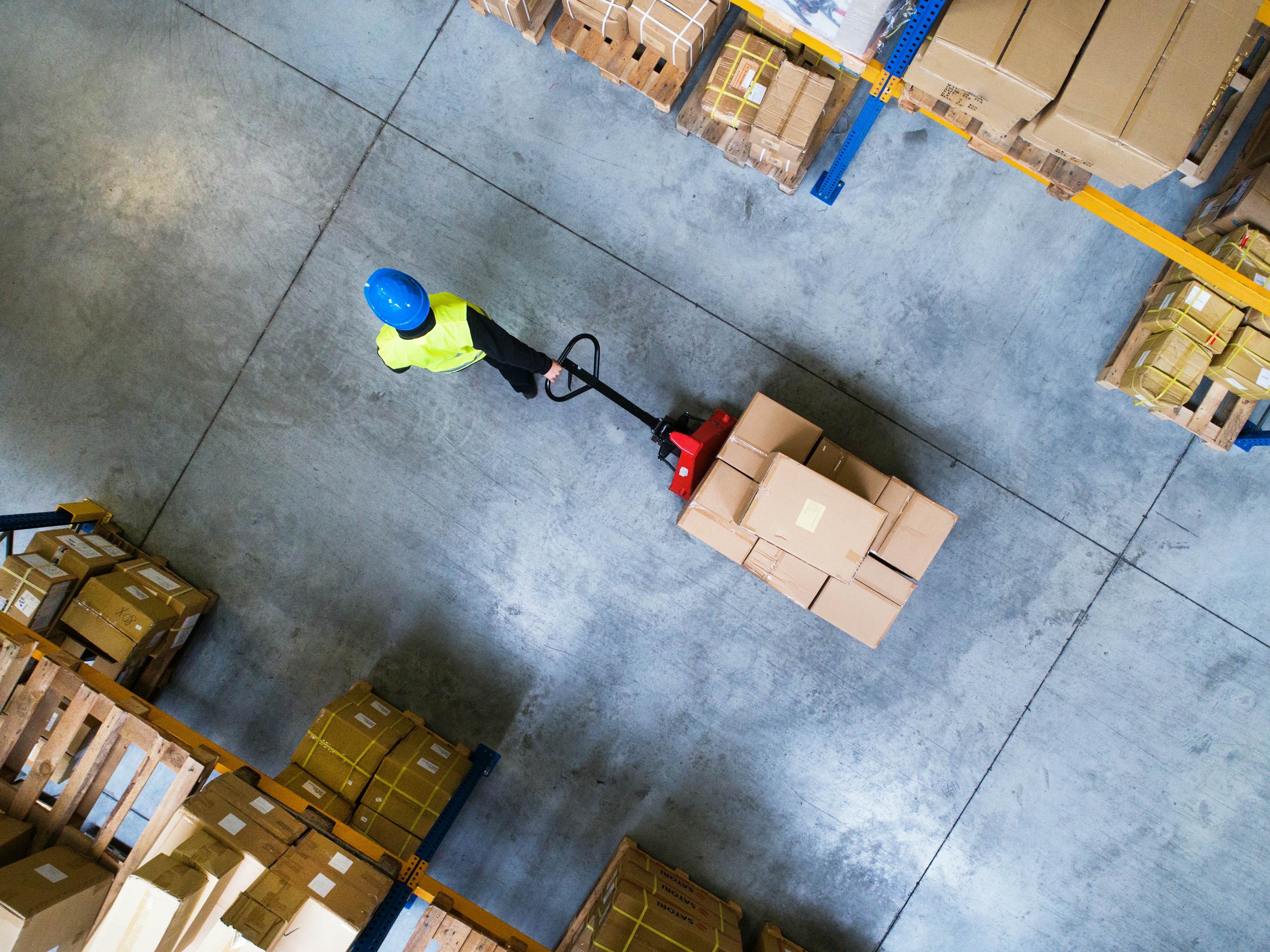 worker pulling boxes in a warehouse