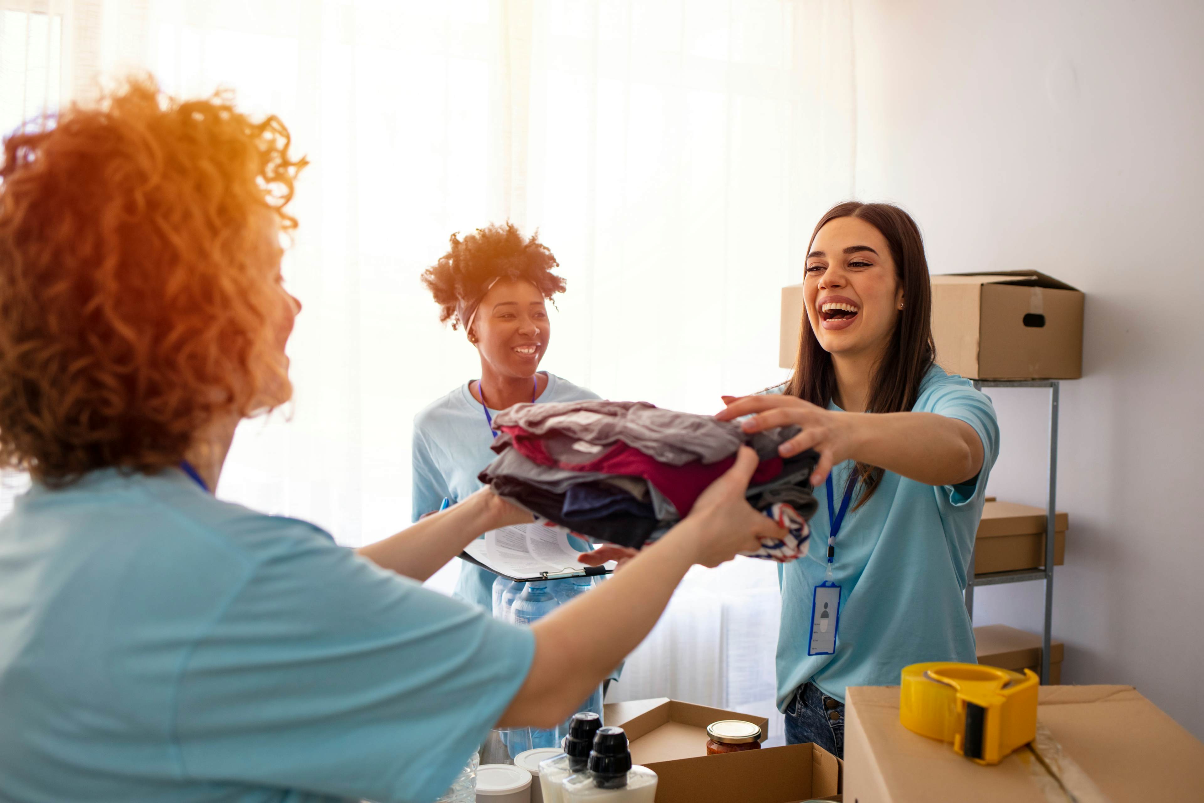 Volunteers handing clothes to one another