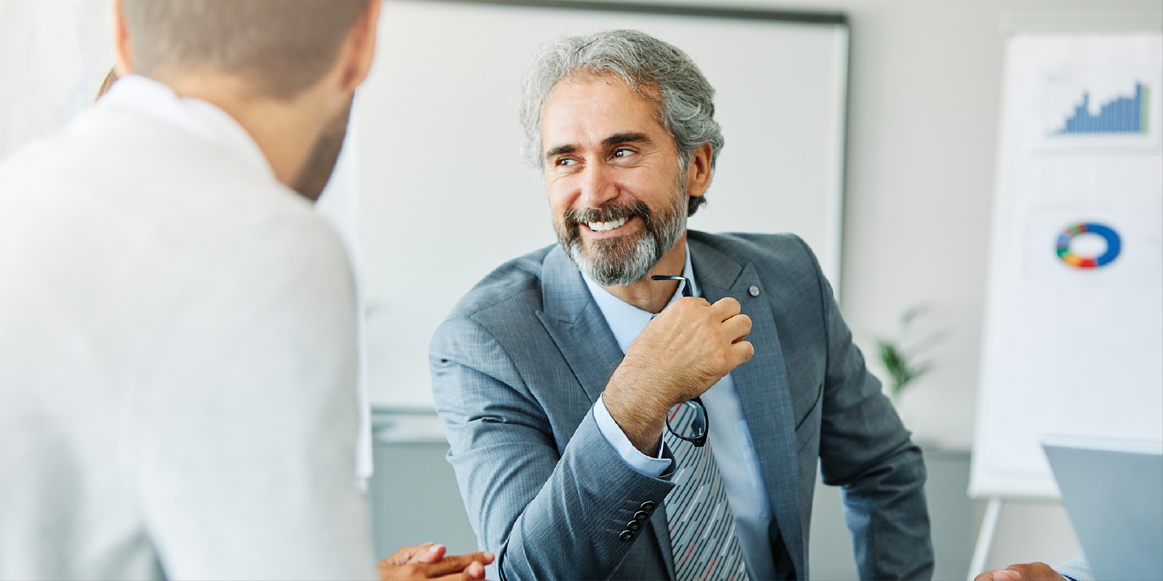 Man interacts with colleague during meeting