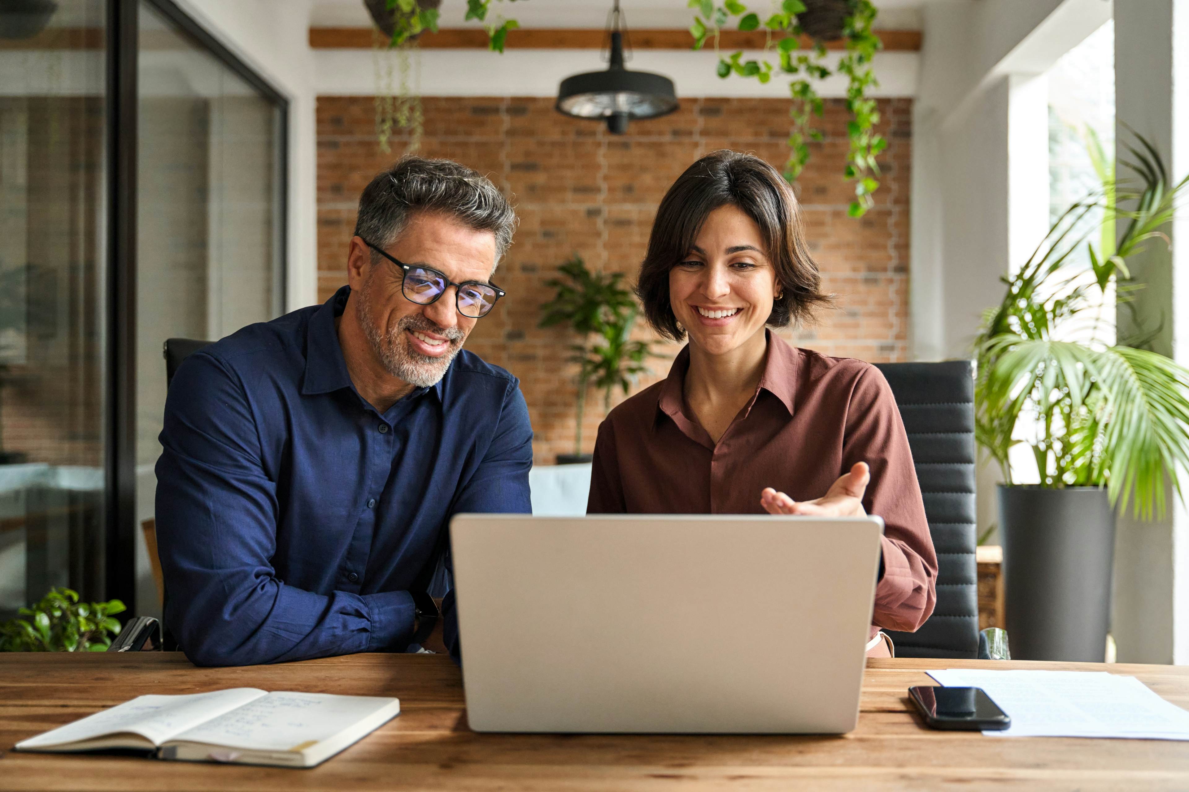 People smiling while viewing their portfolio on computer